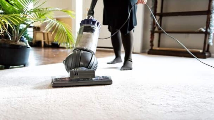 vacuuming carpet - samkinsconstruction